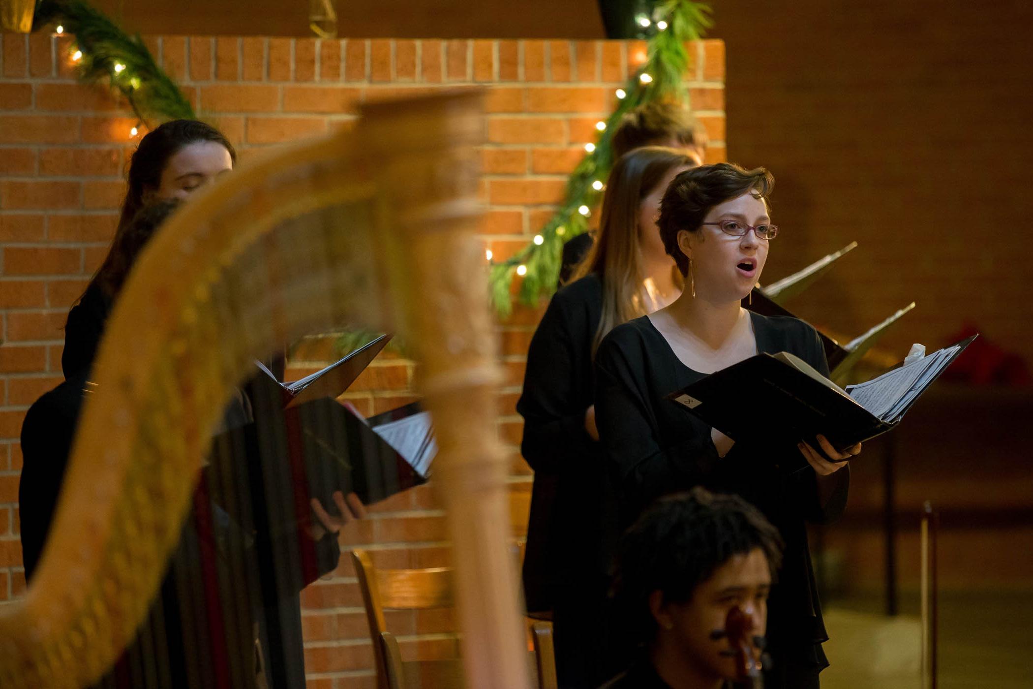 choral singer with a harp in the foreground