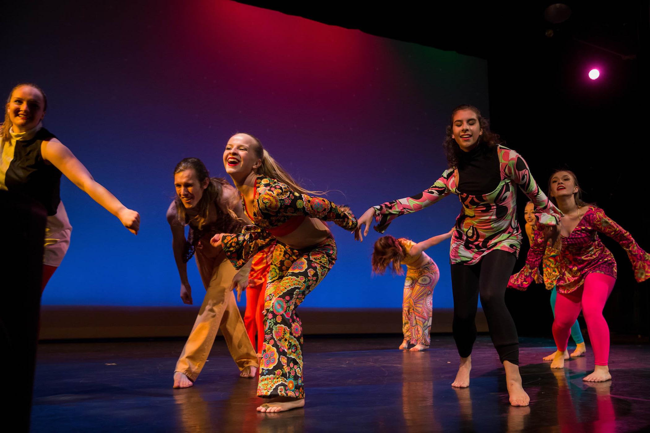 Dancers in colorful costumes perform